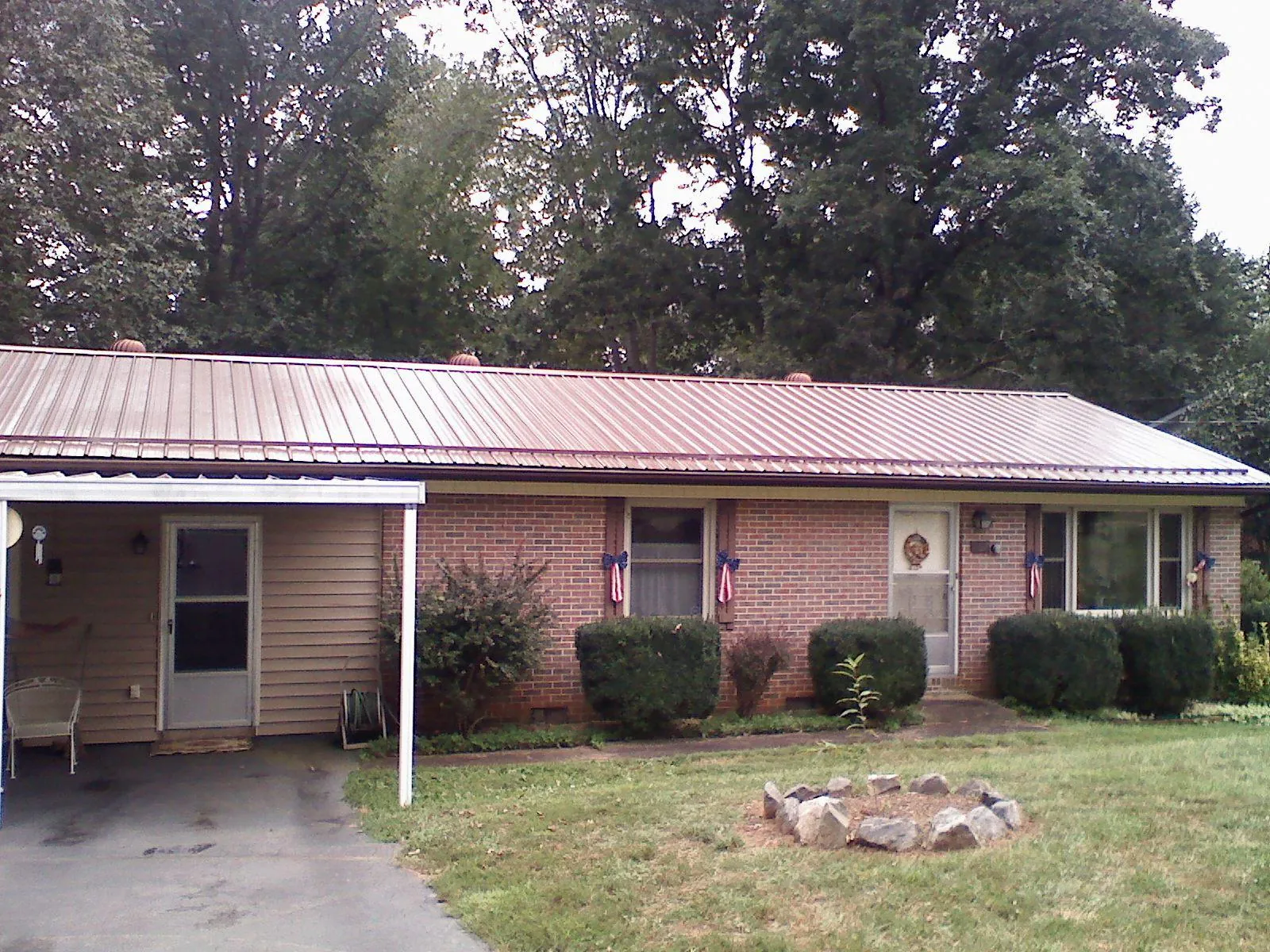 Bronze metal roof and carport on a brick ranch home — Roof Repair work by our crew in Millsboro